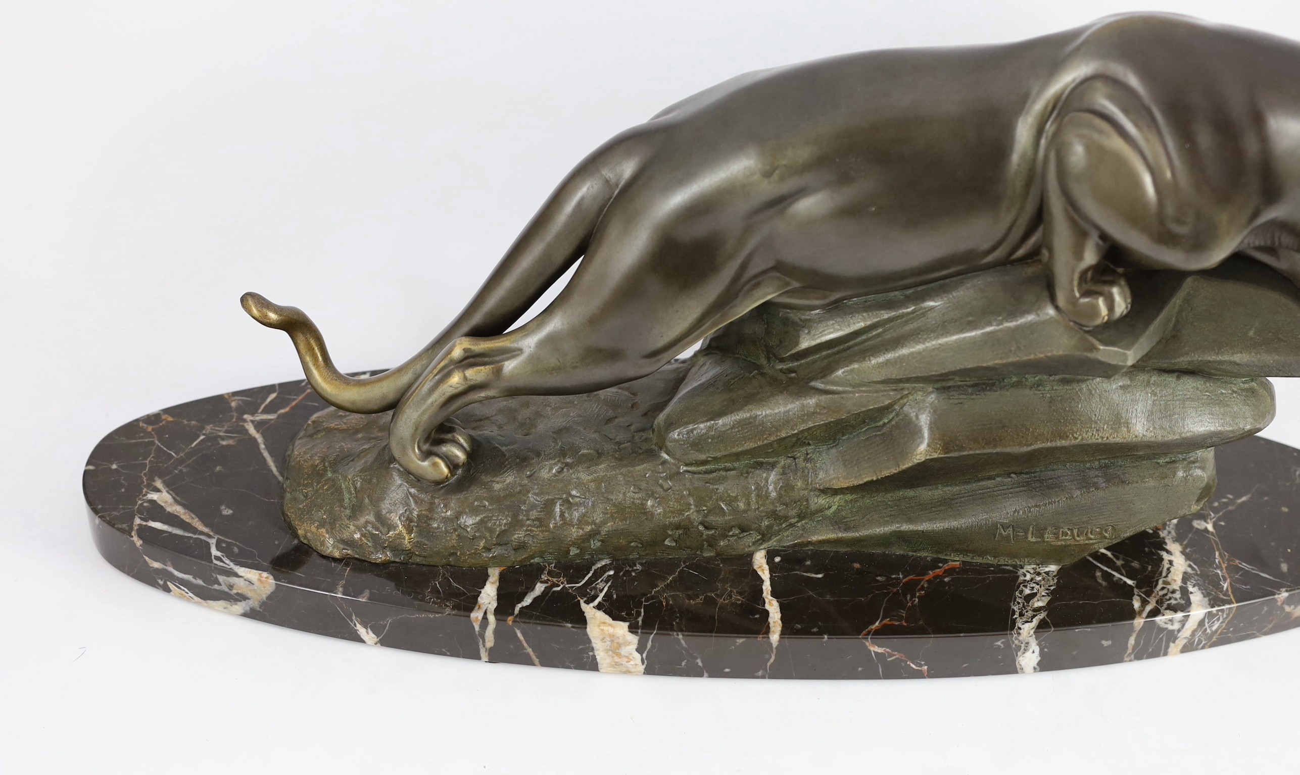 M. Leducq. NB. A patinated spelter model of a panther crouched upon a rock, width 60cm height 29cm